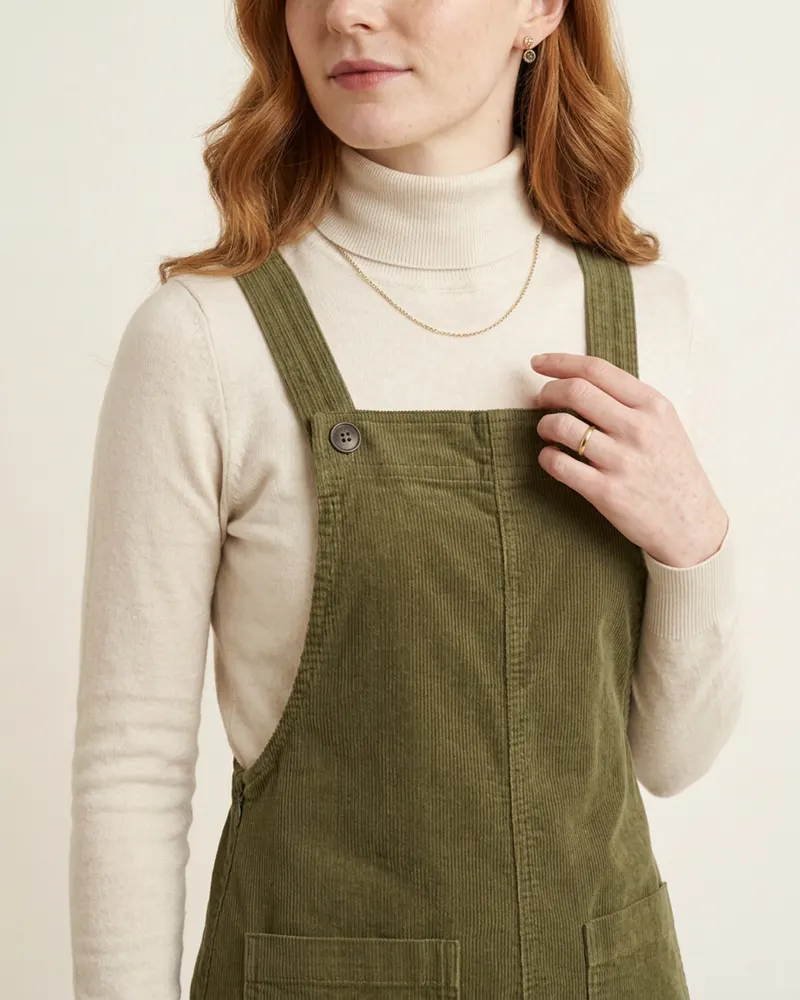 Close-up of the Corduroy Pinafore Dress in Olive: fine-wale cotton corduroy with stretch