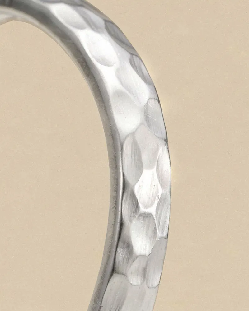 Close-up of the Hammered Oval Bangle in Recycled Silver: solid 4mm oval bangle