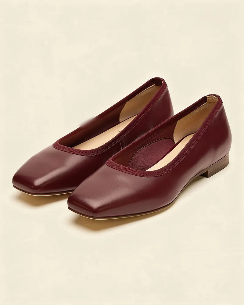 Ines Leather Ballet Flat in Oxblood, a pair shown at three-quarters: nappa leather ballet flats with a soft square toe, a thin elastic topline and a flexible leather sole