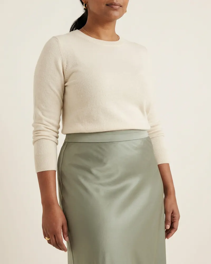 Close-up of the Lumen Bias-Cut Satin Midi Skirt in Sage: bias cut