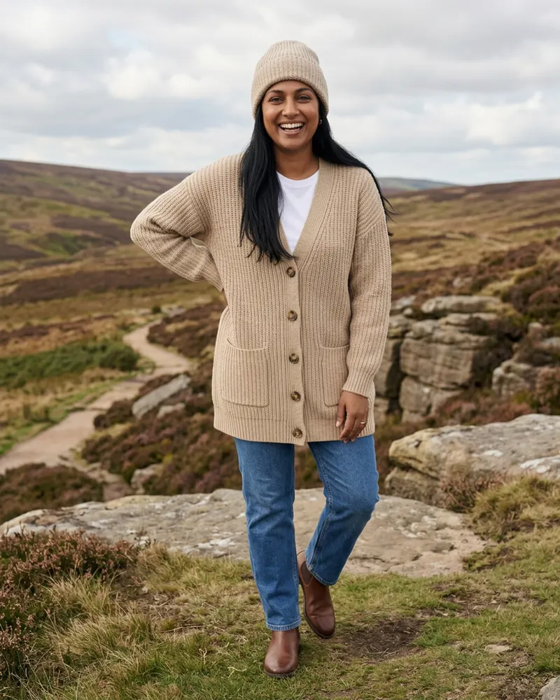 Mabel Chunky Wool Cardigan in Oatmeal, on a moorland walk in the Simonside Hills with a beanie
