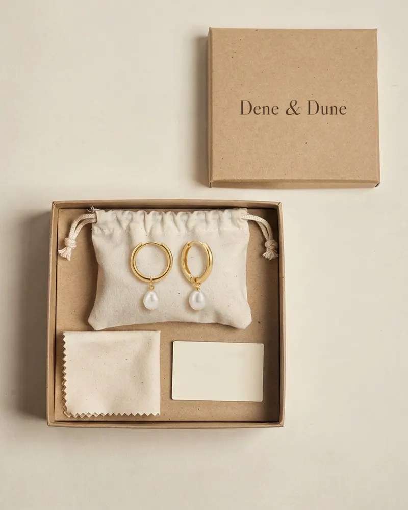 Pearl Charm Huggie Hoop Earrings in Gold Vermeil in its Dene & Dune gift box with pouch and care card