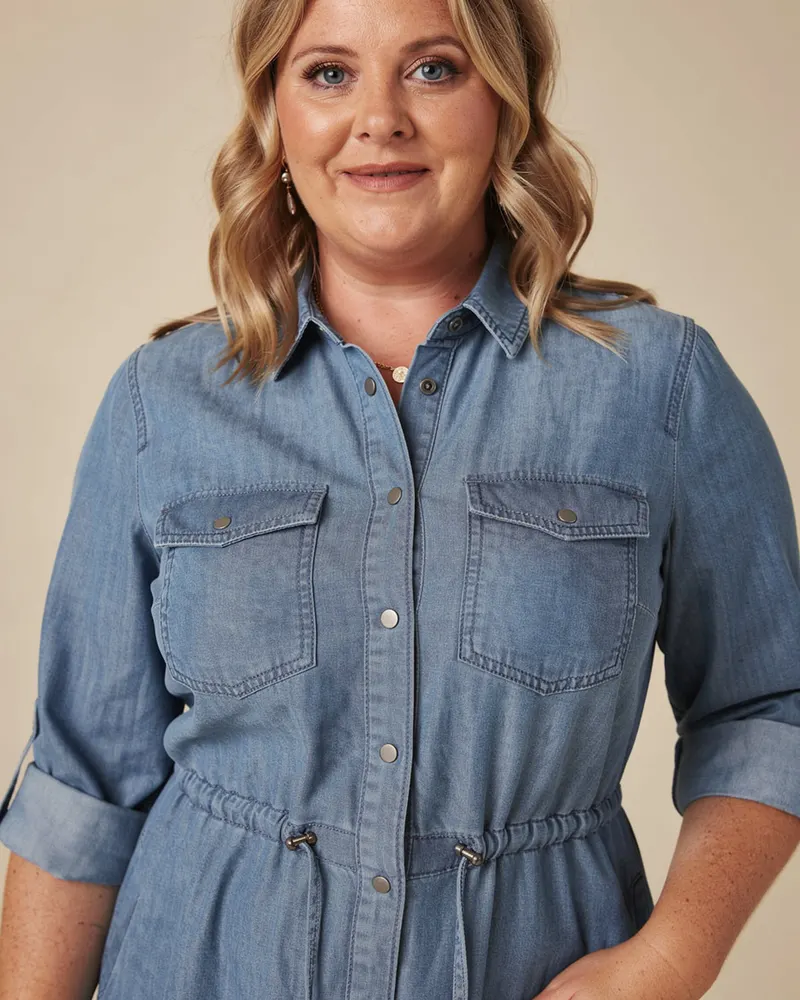 Close-up of the Soft Denim Shirt Dress in Mid Blue: press-stud front